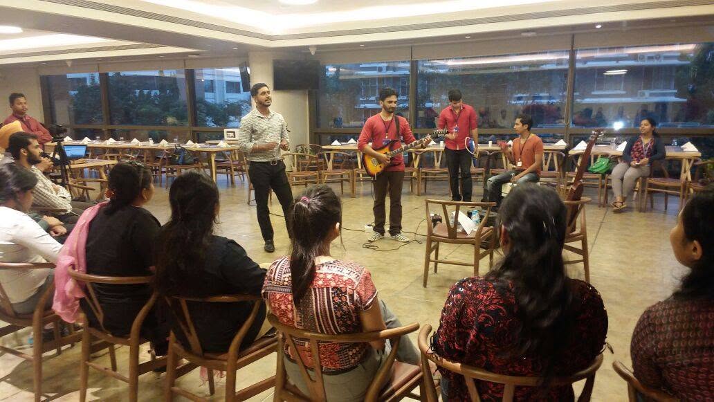 Guitarists performing for a seated audience at a Music Jammin jam