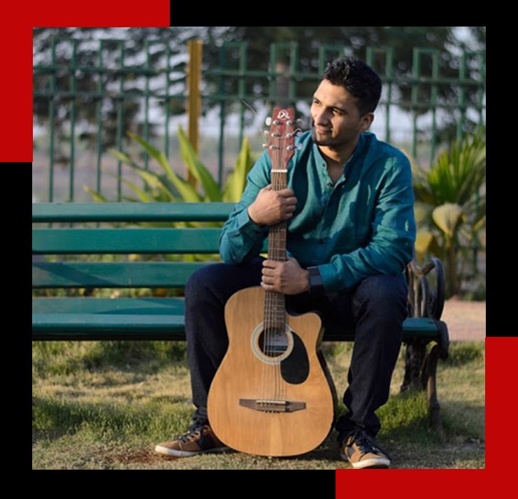 Music Jammin artist seated on a bench with an acoustic guitar